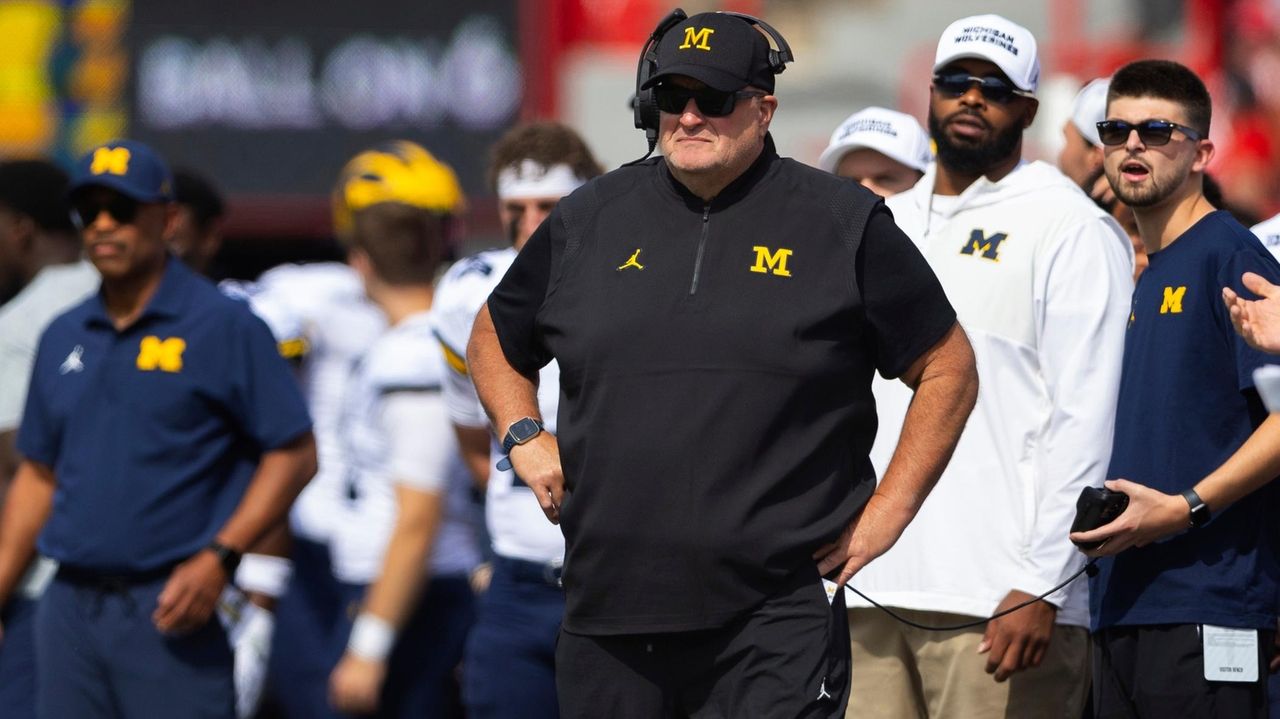 Biff Poggi tells signees and parents Michigan hopes to hire a coach by end of month, AP source says