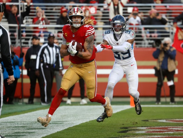 San Francisco 49ers' George Kittle (85) makes a catch for a touchdown against Tennessee Titans' Darrell Baker Jr. (39) in the third quarter at Levi's Stadium in Santa Clara, Calif., on Sunday, Dec. 14, 2025. (Nhat V. Meyer/Bay Area News Group)