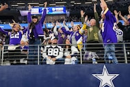 Minnesota Vikings fans celebrate around two Dallas Cowboys fans during the second half of an...
