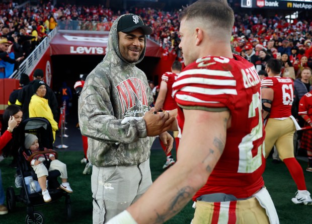 San Francisco 49ers' Fred Warner (54) high-fives San Francisco 49ers' Christian McCaffrey (23) after their 37-24 win over the Tennessee Titans at Levi's Stadium in Santa Clara, Calif., on Sunday, Dec. 14, 2025. (Nhat V. Meyer/Bay Area News Group)