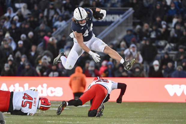 FILE - Penn State tight end Tyler Warren (44) hurdles Maryland defensive back Kevis Thomas (25) during the second quarter of an NCAA college football game, Saturday, Nov. 30, 2024, in State College, Pa. (AP Photo/Barry Reeger, File)