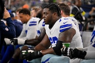 Dallas Cowboys guard Tyler Smith (73) looks on from the team bench during an NFL football...