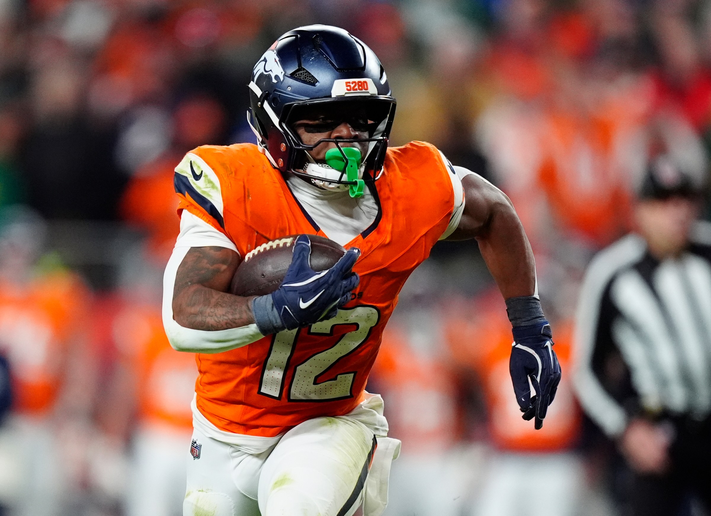 Dec 14, 2025; Denver, Colorado, USA; Denver Broncos running back RJ Harvey (12) runs for a gain during the fourth quarter against the Green Bay Packers at Empower Field at Mile High. Mandatory Credit: Ron Chenoy-Imagn Images
