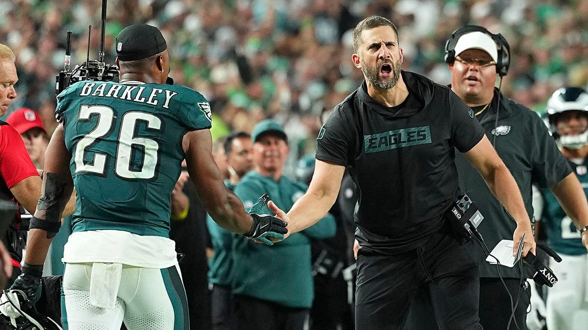 Nick Sirianni shakes hands with Saquon Barkley