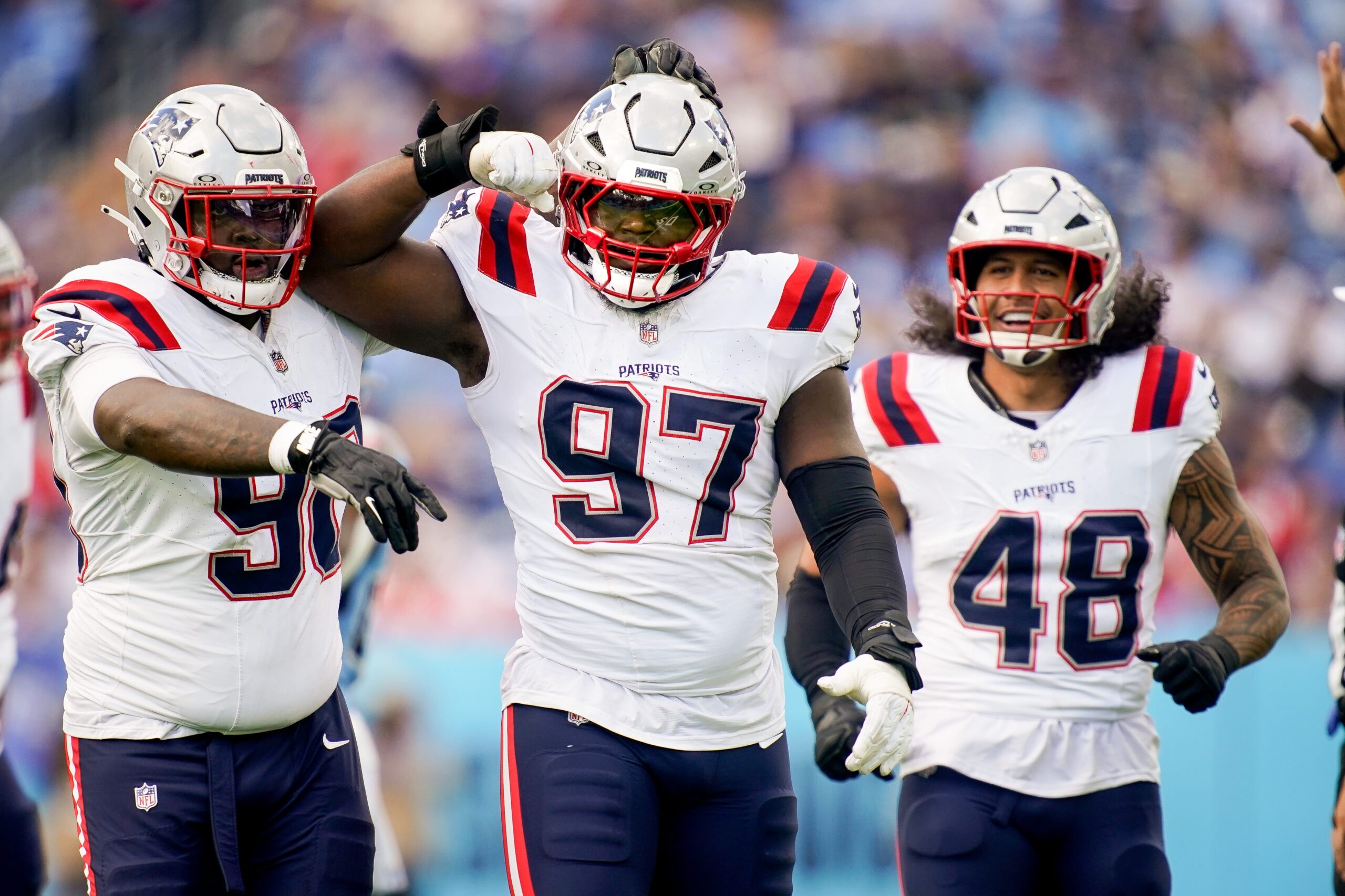 New England Patriots defensive end Milton Williams (97) celebrates sacking Tennessee Titans quarterback Cam Ward (1) during the third quarter at Nissan Stadium in Nashville, Tenn., Sunday, Oct. 19, 2025.