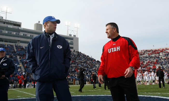 (Chris Detrick | The Salt Lake Tribune) BYU head coach Bronco Mendenhall and Utah head coach Kyle Whittingham meet at the center of the field before the start of a game at Lavell Edwards Stadium in Provo, Utah, Saturday, Nov. 28, 2009.