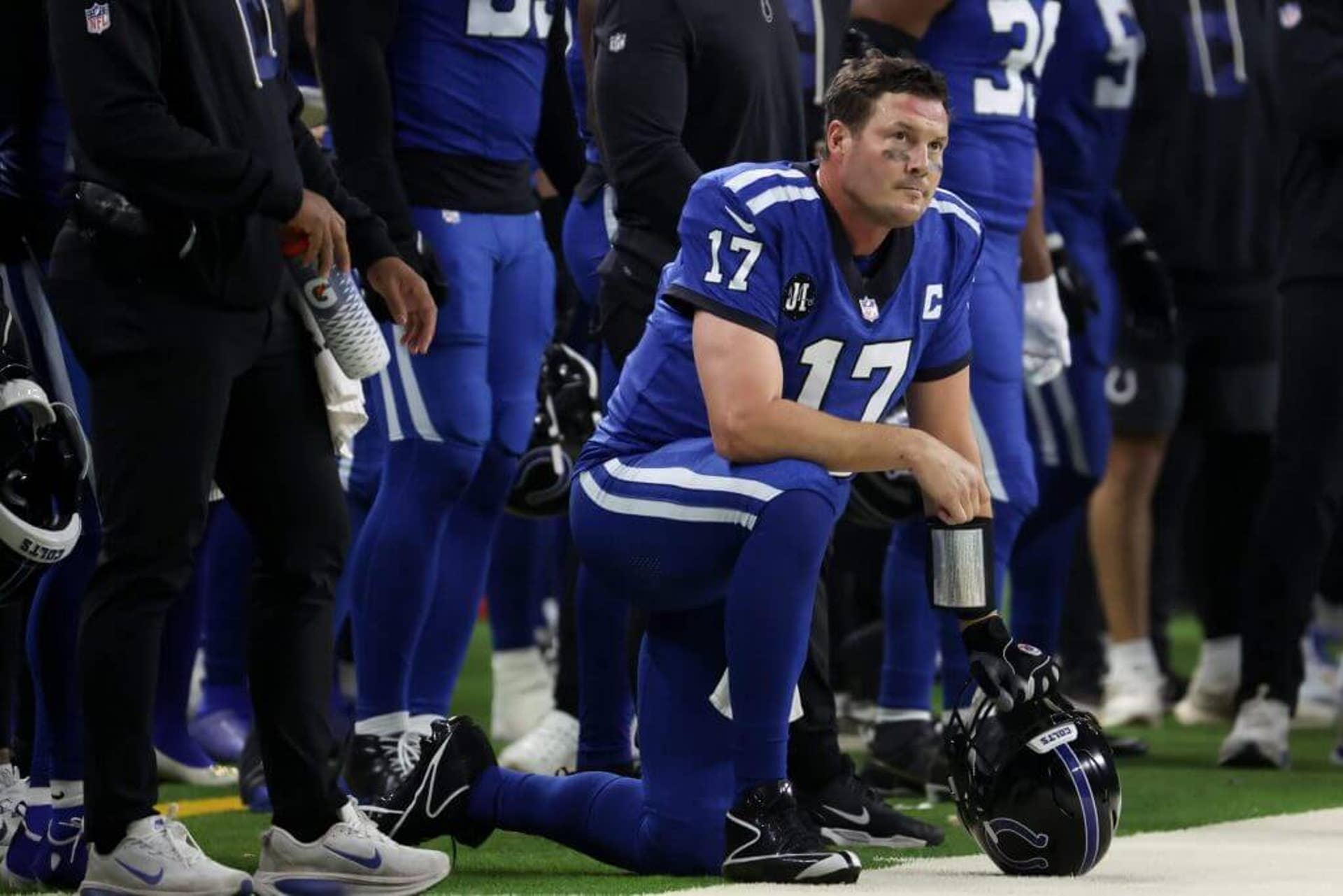 Colts quarterback Philip Rivers (17) watches while kneeling on the sideline as Indianapolis plays the San Francisco 49ers.