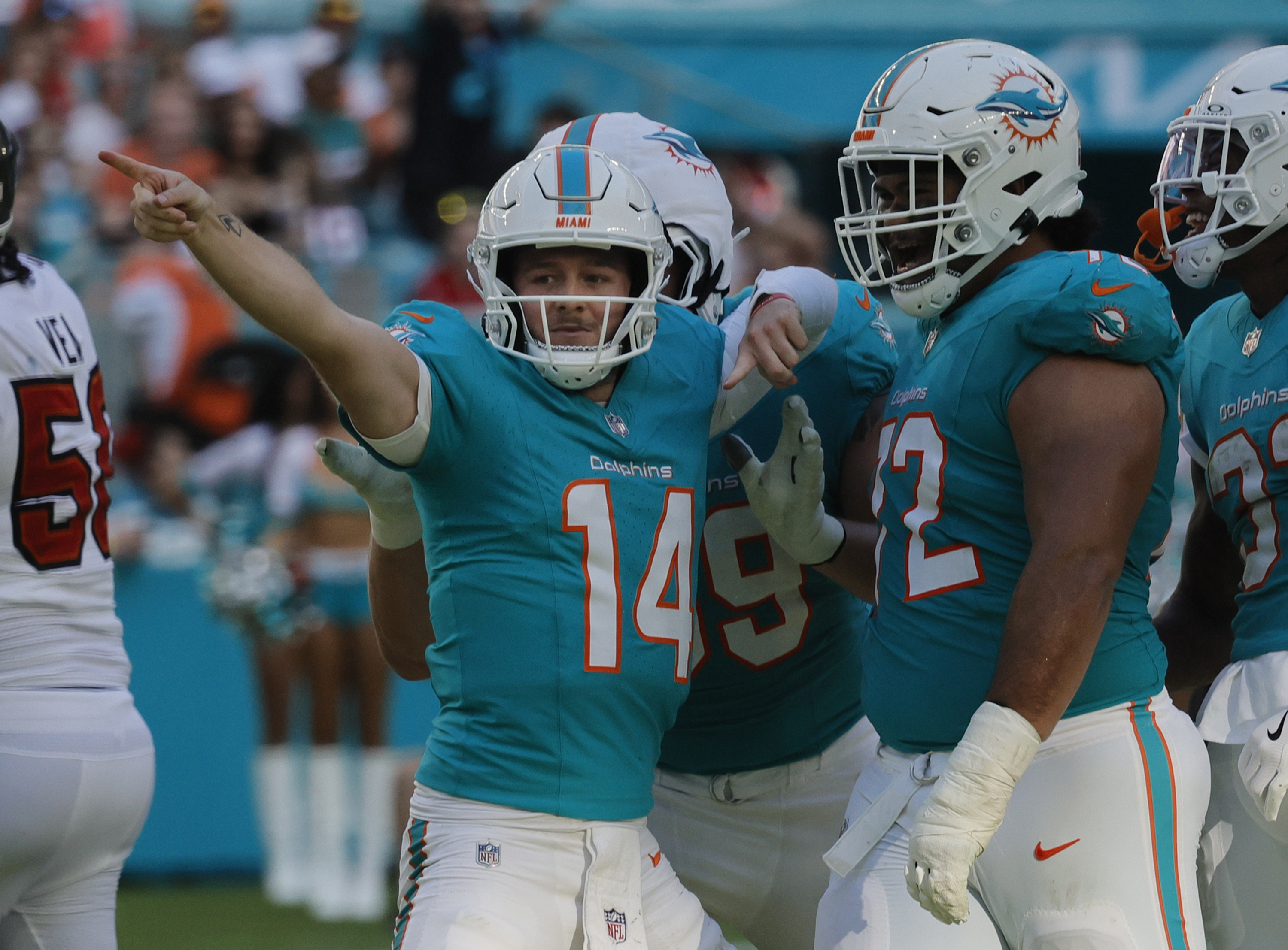 Miami Dolphins quarterback Quinn Ewers (14) celebrates after running for a first down against the Tampa Bay Buccaneers, Sunday, Dec. 28, 2025, at Hard Rock Stadium in Miami Gardens. (Joe Cavaretta/South Florida Sun Sentinel)