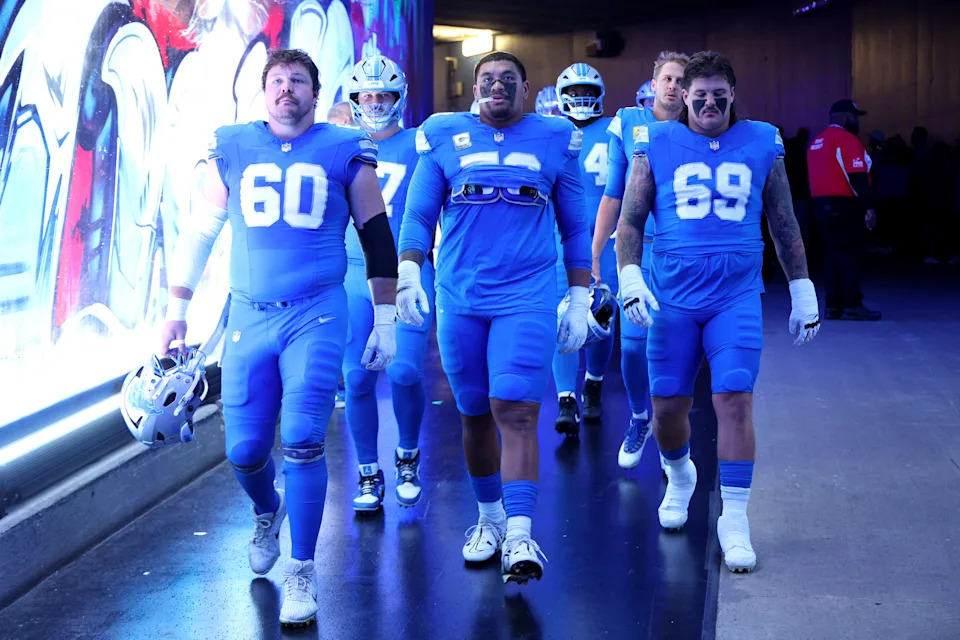 Detroit Lions offensive linemen left to right: Graham Glasgow, Penei Sewell and Tate Ratledge walk through the tunnel prior to the game against the Minnesota Vikings at Ford Field on Nov. 2, 2025 in Detroit.