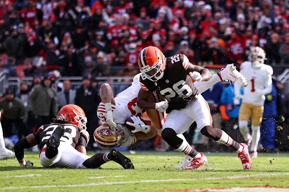 Nov 30, 2025; Cleveland, Ohio, USA; Cleveland Browns cornerback Myles Harden (26) tackles San Francisco 49ers running back Christian McCaffrey (23) during the first half at Huntington Bank Field. Mandatory Credit: Scott Galvin-Imagn Images