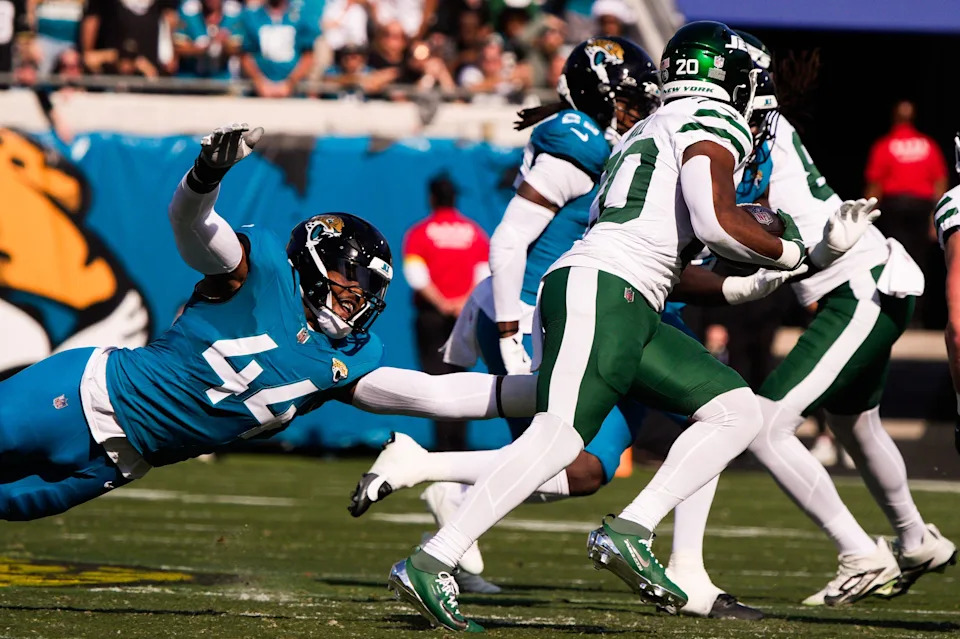 Jacksonville Jaguars defensive end Travon Walker (44) tries to tackle New York Jets running back Breece Hall (20) during the first quarter during an NFL football game at EverBank Stadium, Sunday, Dec. 14, 2025, in Jacksonville, Fla. [Doug Engle/Florida Times-Union]