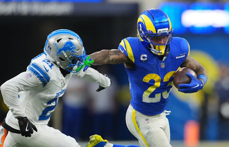 Los Angeles Rams running back Kyren Williams (23) runs the ball against Detroit Lions cornerback Amik Robertson (21) during the fourth quarter at SoFi Stadium in Inglewood, California, on Sunday, Dec. 14, 2025.