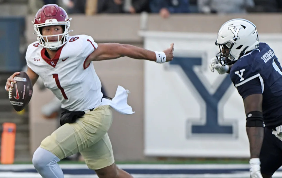 NEW HAVEN, CONNECTICUT - NOVEMBER 22: Jaden Craig #1 of the Harvard Crimson flees Zairion Jackson-Bass #1 of the Yale Bulldogs in the second half of the 141st playing of "The Game" at Yale Bowl on November 22, 2025 in New Haven, Connecticut. (Photo by Sean D. Elliot/Getty Images)