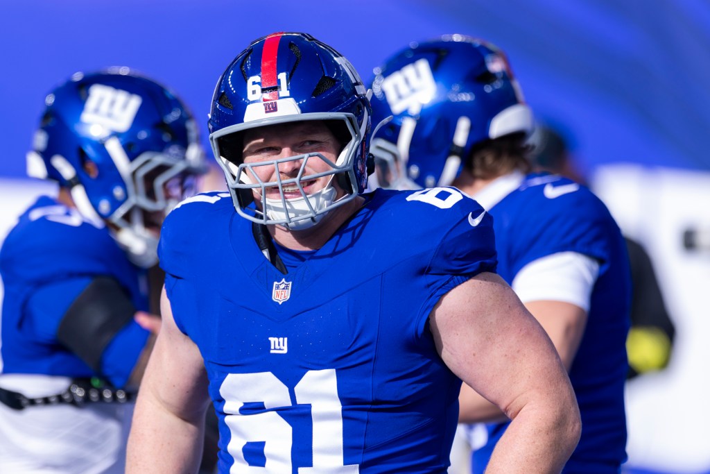 Center John Michael Schmitz Jr. #61 of the New York Giants is all smiles on the field during warm-ups before the first half at MetLife Stadium, Sunday, Dec. 21, 2025, in East Rutherford, New Jersey.