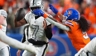 Las Vegas Raiders quarterback Geno Smith (7) is sacked by Denver Broncos safety Talanoa Hufanga ...