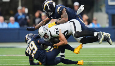 Las Vegas Raiders tight end Brock Bowers (89) is tackled by Los Angeles Chargers cornerback Tar ...