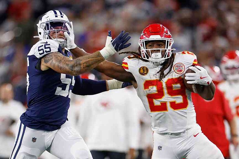 Kansas City Chiefs running back Kareem Hunt (29) runs with the ball past Dallas Cowboys linebacker Logan Wilson (55) during the second half of an NFL football game Thursday, Nov. 27, 2025, in Arlington, Texas. (AP Photo/Gareth Patterson)