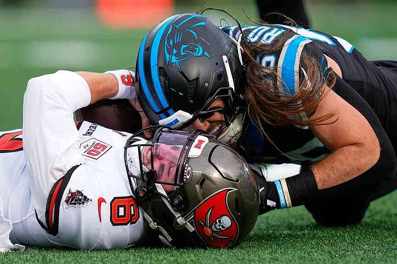Tampa Bay Buccaneers quarterback Baker Mayfield is sacked by Carolina Panthers linebacker Christian Rozeboom during the first half of an NFL football game, Sunday, Dec. 21, 2025, in Charlotte, N.C. (AP Photo/Erik Verduzco)