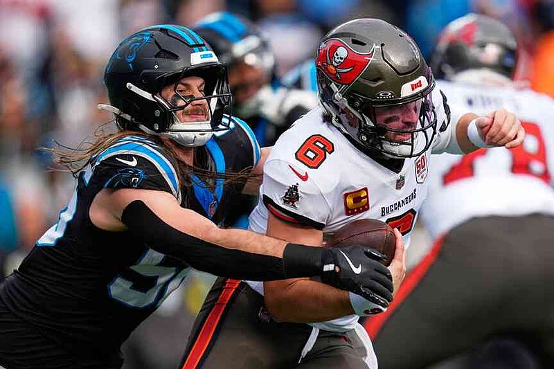 Tampa Bay Buccaneers quarterback Baker Mayfield is sacked by Carolina Panthers linebacker Christian Rozeboom during the first half of an NFL football game, Sunday, Dec. 21, 2025, in Charlotte, N.C. (AP Photo/Erik Verduzco)