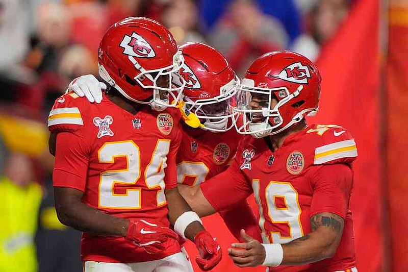 Kansas City Chiefs running back Brashard Smith (24) celebrates with wide receiver Juju Smith-Schuster, center, and quarterback Chris Oladokun (19) after scoring a touchdown during the first half of an NFL football game against the Denver Broncos Thursday, Dec. 25, 2025, in Kansas City, Mo. (AP Photo/Charlie Riedel)