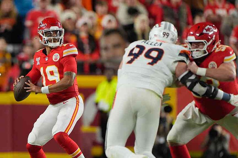 Kansas City Chiefs quarterback Chris Oladokun (19) looks to pass as teammate center Creed Humphrey, right, blocks Denver Broncos defensive end Zach Allen (99) during the first half of an NFL football game Thursday, Dec. 25, 2025, in Kansas City, Mo. (AP Photo/Charlie Riedel)