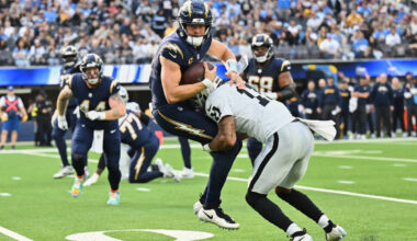 Los Angeles Chargers quarterback Justin Herbert (10) is tackled by Las Vegas Raiders safety Jer ...