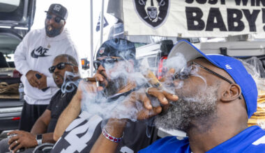 Fans enjoy cigars in the tailgating area before the start of the Raiders against the New York G ...