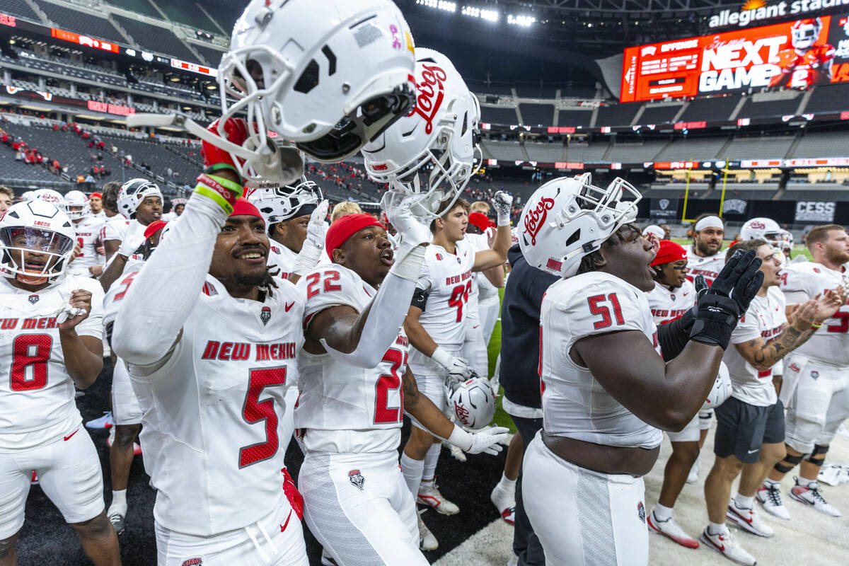 New Mexico Lobos players celebrate their win over UNLV 40-35 with the fans following the second ...