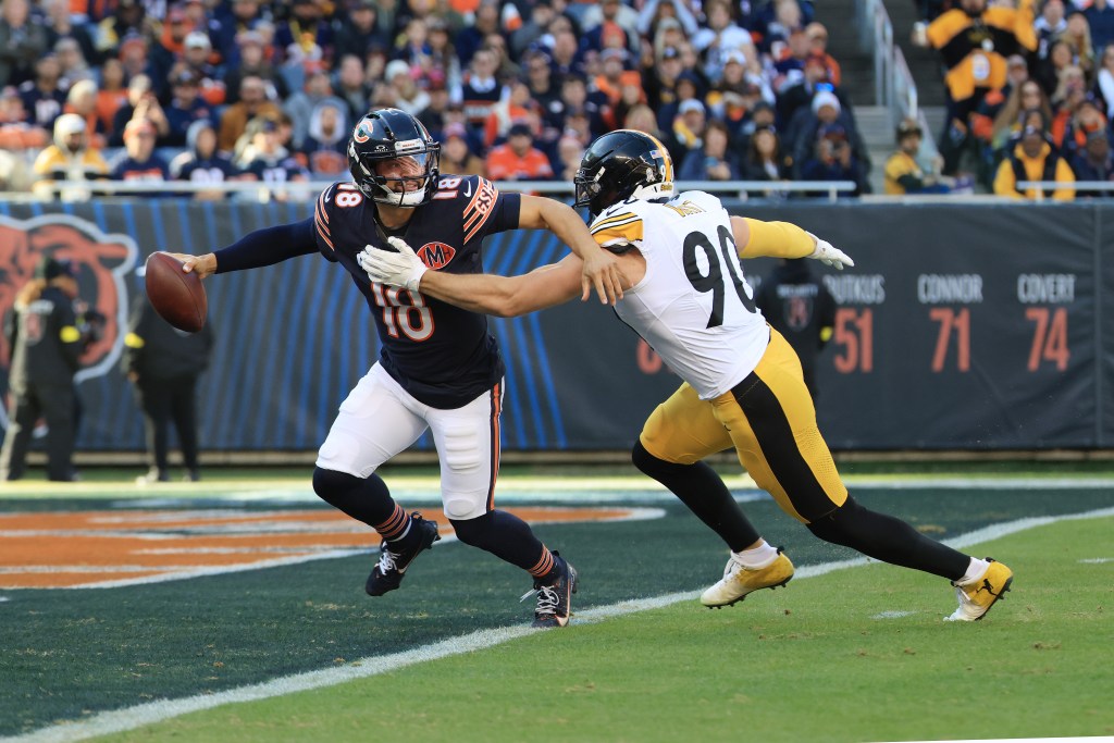 T.J. Watt #90 of the Pittsburgh Steelers pressures Caleb Williams #18 of the Chicago Bears before forcing a fumble during the second quarter at Soldier Field on November 23, 2025 in Chicago, Illinois.