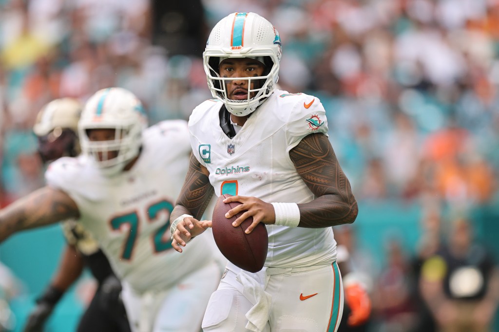 Tua Tagovailoa #1 of the Miami Dolphins carries the ball against the New Orleans Saints during the fourth quarter at Hard Rock Stadium on November 30, 2025 in Miami Gardens, Florida.