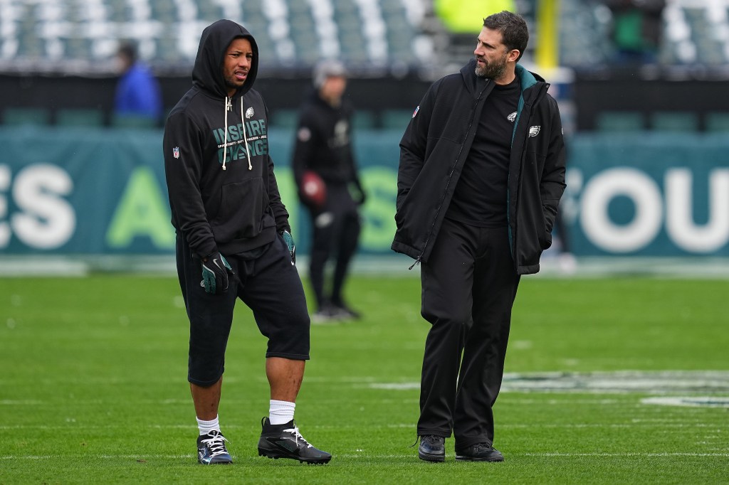 Head coach Nick Sirianni of the Philadelphia Eagles speaks with Saquon Barkley #26 during warmups before the game against the Las Vegas Raiders at Lincoln Financial Field on December 14, 2025 in Philadelphia, Pennsylvania. 