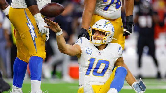 Justin Herbert #10 of the Los Angeles Chargers reacts after being sacked in the second half during the AFC Wild Card Playoff game against the Houston Texans at NRG Stadium on January 11, 2025 in Houston, Texas.