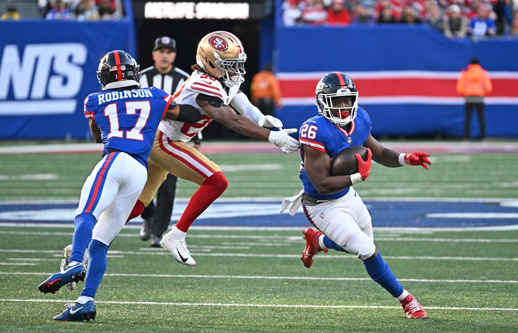 Devin Singletary #26 of the New York Giants runs the ball as WanDale Robinson #17 of the New York Giants defends during the fourth quarter of the Giants and San Francisco 49ers game in East Rutherford, NJ. 