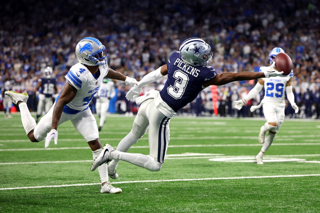 Dallas Cowboys player George Pickens drops a pass against D.J. Reed of the Detroit Lions.