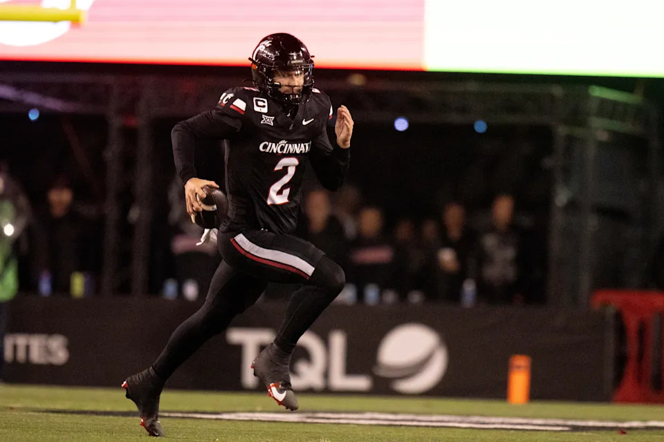 Cincinnati Bearcats quarterback Brendan Sorsby (2) runs for a first down in the fourth quarter of the NCAA football game between the Cincinnati Bearcats and BYU Cougars at Nippert Stadium in Cincinnati on Nov. 22, 2025.