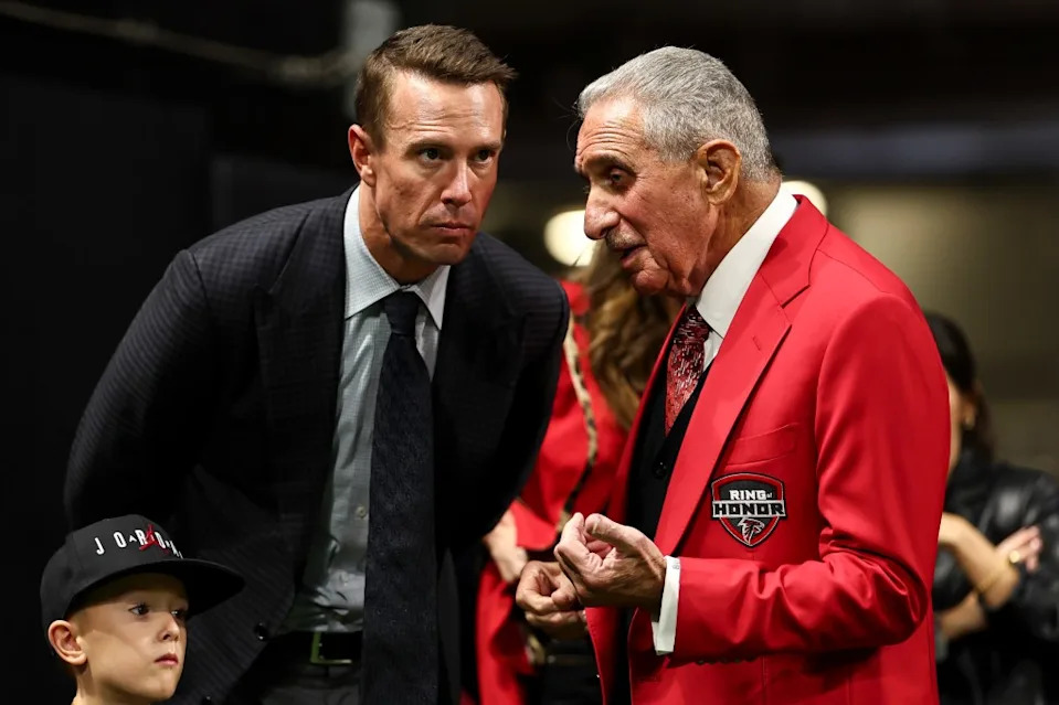 Matt Ryan (l.) talks with Falcons owner Arthur Blank (r.) in 2024. Getty Images