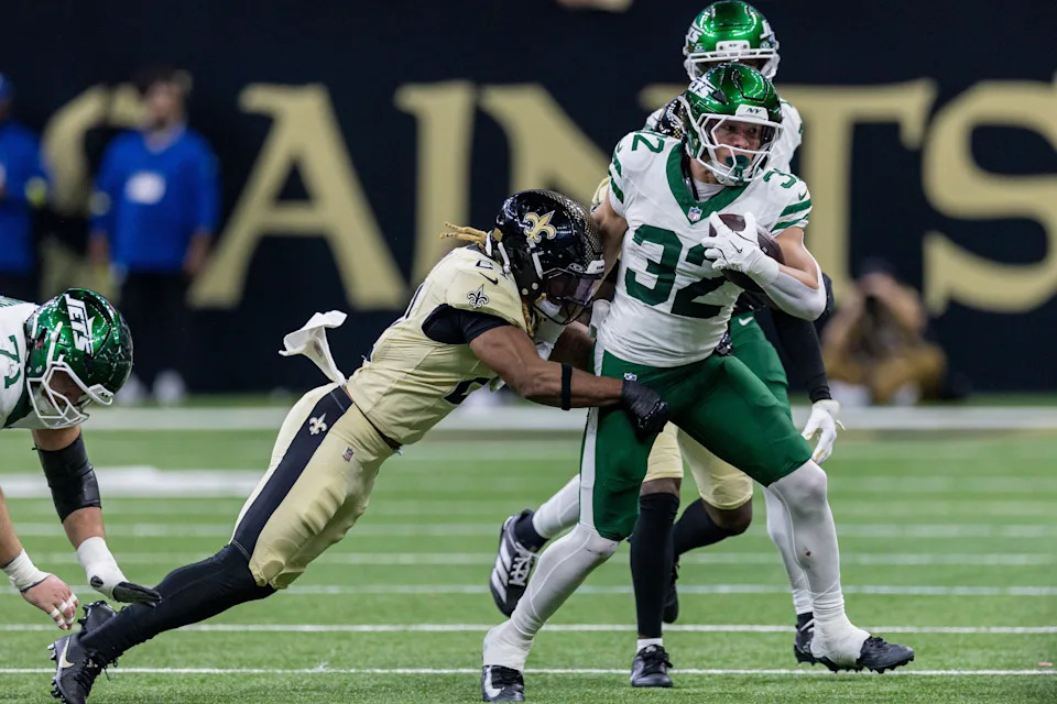Dec 21, 2025; New Orleans, Louisiana, USA; New York Jets running back Isaiah Davis (32) is tackled by New Orleans Saints safety Justin Reid (21) during the second half at Caesars Superdome. Mandatory Credit: Stephen Lew-Imagn Images