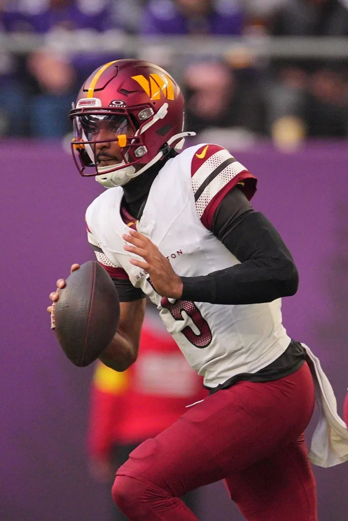 Washington Commanders quarterback Jayden Daniels (5) drops back to pass against the Minnesota Vikings during the first half at U.S. Bank Stadium. Brad Rempel-Imagn Images