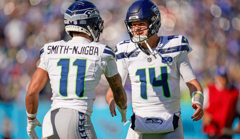 Jaxon Smith-Njigba (11) celebrates his touchdown with quarterback Sam Darnold.