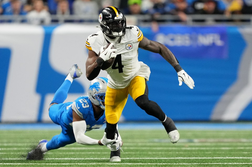 DK Metcalf #4 of the Pittsburgh Steelers runs with the ball as Thomas Harper #12 of the Detroit Lions attempts a tackle during the third quarter at Ford Field