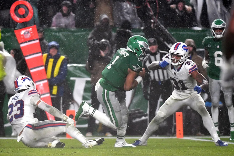 Nov 26, 2023; Philadelphia, Pennsylvania, USA; Philadelphia Eagles quarterback Jalen Hurts (1) scores the game-winning touchdown on a 12-yard run in overtime against Buffalo Bills safety Micah Hyde (23) and cornerback Rasul Douglas (31) at Lincoln Financial Field. Mandatory Credit: Eric Hartline-USA TODAY Sports