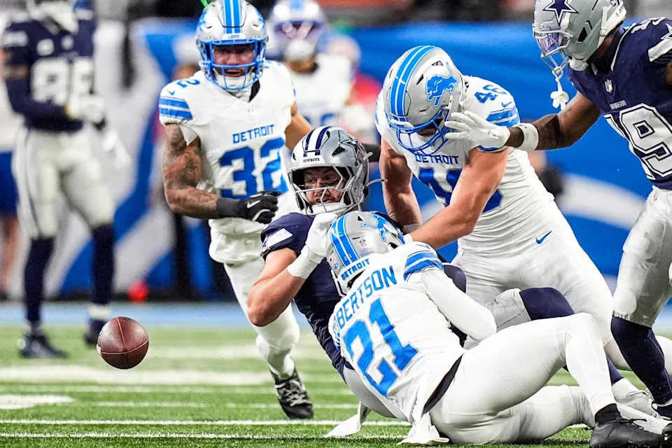Detroit Lions linebacker Jack Campbell (46) and cornerback Amik Robertson (21) force Dallas Cowboys tight end Jake Ferguson (87) to fumble during the first half at Ford Field in Detroit on Thursday, Dec. 4, 2025.