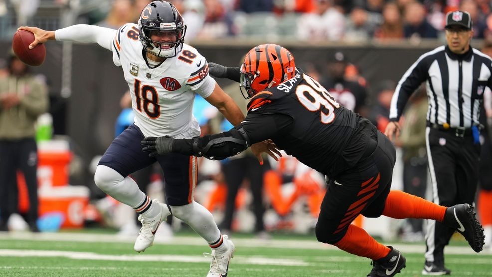 Cincinnati Bengals defensive tackle T.J. Slaton Jr. (98) pressures Chicago Bears quarterback Caleb Williams (18) during the first half of an NFL football game, Sunday, Nov. 2, 2025, in Cincinnati. (AP Photo/Jeff Dean)