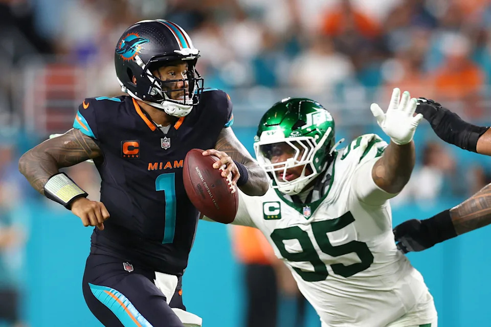 MIAMI GARDENS, FLORIDA - SEPTEMBER 29: Tua Tagovailoa #1 of the Miami Dolphins is pursued by Quinnen Williams #95 of the New York Jets during the second half at Hard Rock Stadium on September 29, 2025 in Miami Gardens, Florida. (Photo by Megan Briggs/Getty Images)