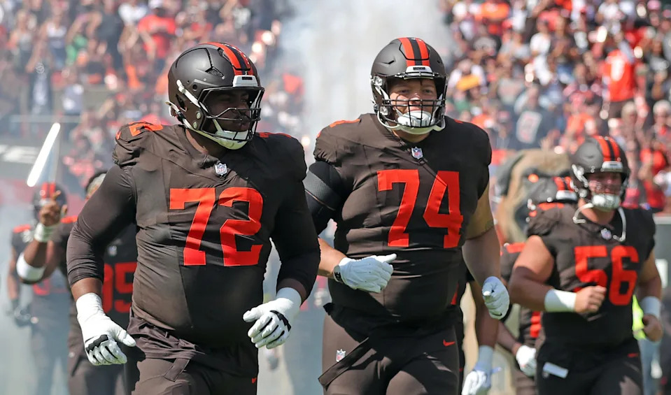 Cleveland Browns offensive tackle KT Leveston (72) and guard Teven Jenkins (74) take the field before an NFL football game at Huntington Bank Field, Sept. 21, 2025, in Cleveland, Ohio.
