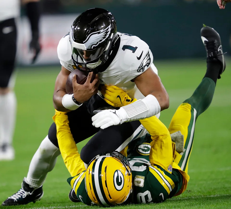 Green Bay Packers safety Xavier McKinney forces a fumble by Philadelphia Eagles quarterback Jalen Hurts.