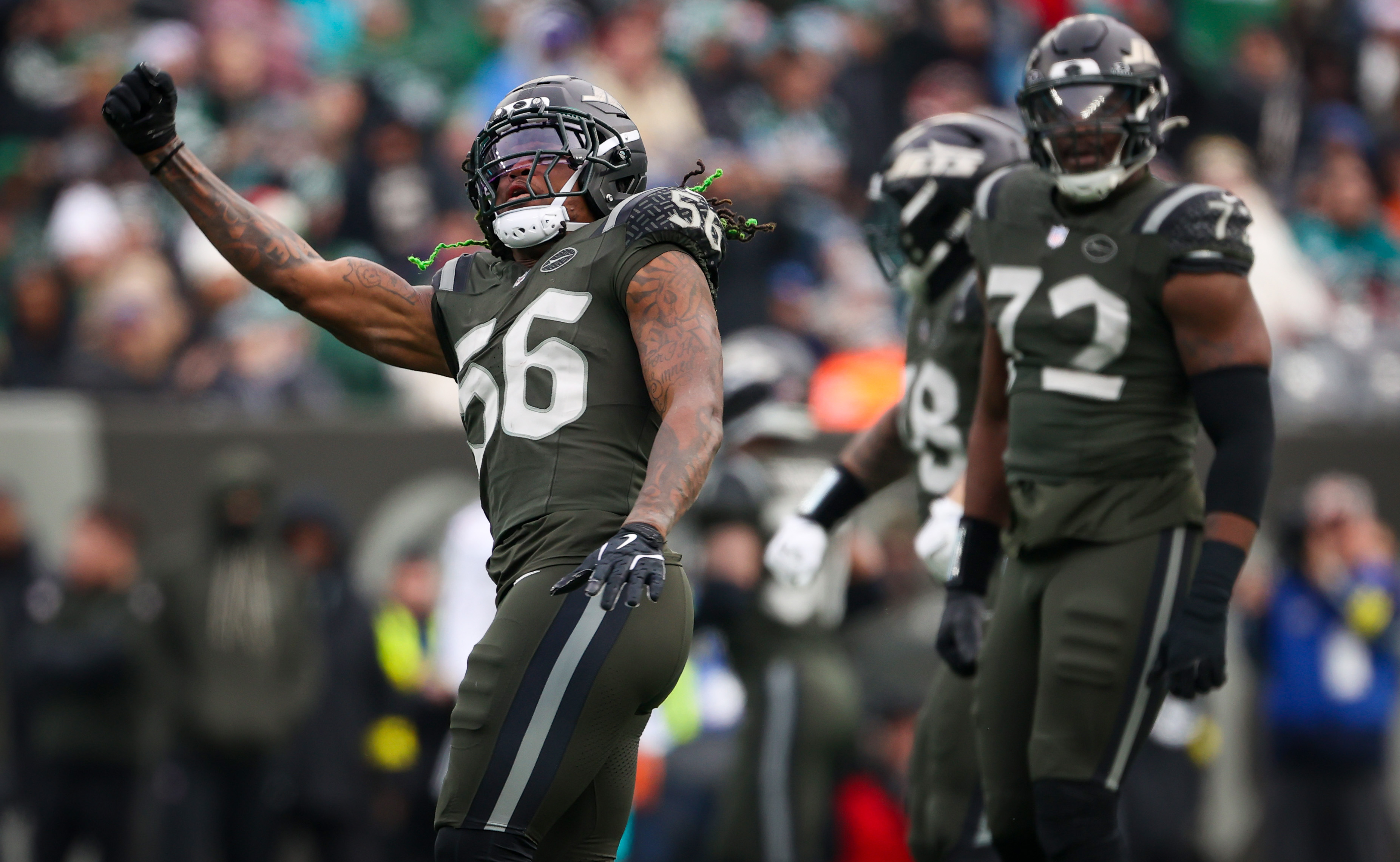 New York Jets linebacker Quincy Williams (56) and defensive end Micheal Clemons (72) react after they sacked Miami Dolphins quarterback Tua Tagovailoa during the second quarter, Sunday, Dec. 7, 2025 at MetLife Stadium in East Rutherford, N.J.