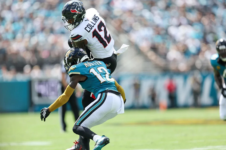 Houston Texans wide receiver Nico Collins is tackled by Jacksonville Jaguars defensive back Travis Hunter.