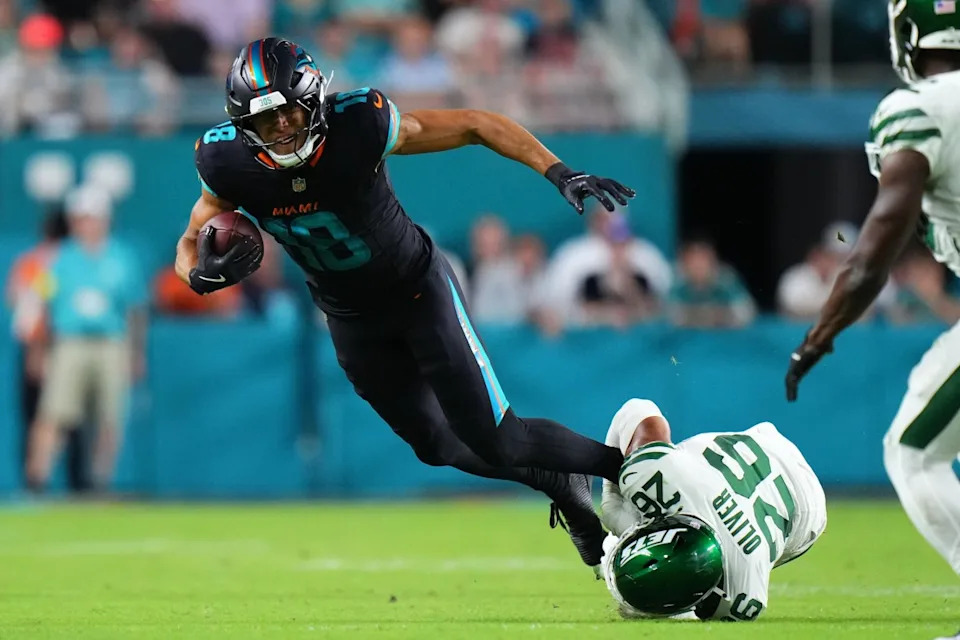 Miami Dolphins wide receiver Nick Westbrook-Ikhine (18) makes a catch against New York Jets safety Isaiah Oliver (26) during the second half at Hard Rock Stadium.Rich Storry-Imagn Images