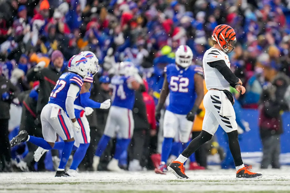 Joe Burrow walks off the field after throwing an interception that was returned 63 yards for a touchdown by Christian Benford. The fourth-quarter score gave the Bills their first lead of the game 32-28.